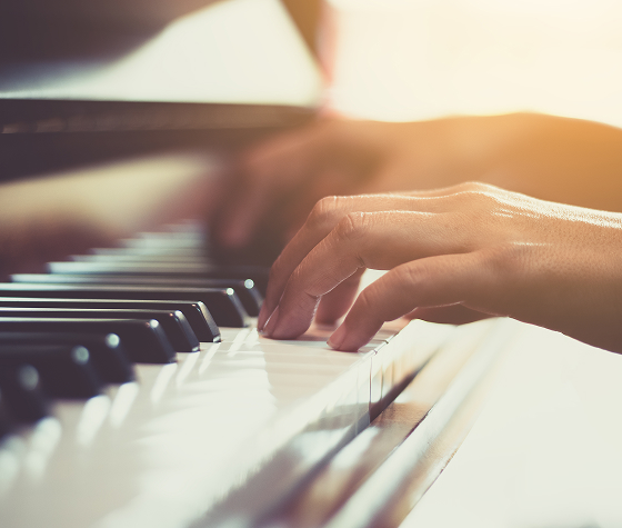 Fingers touching a piano