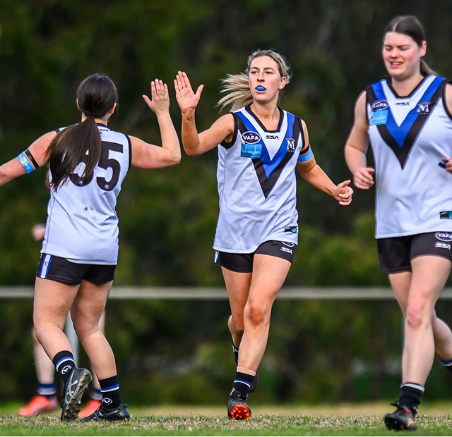 Two girls high fiving each other